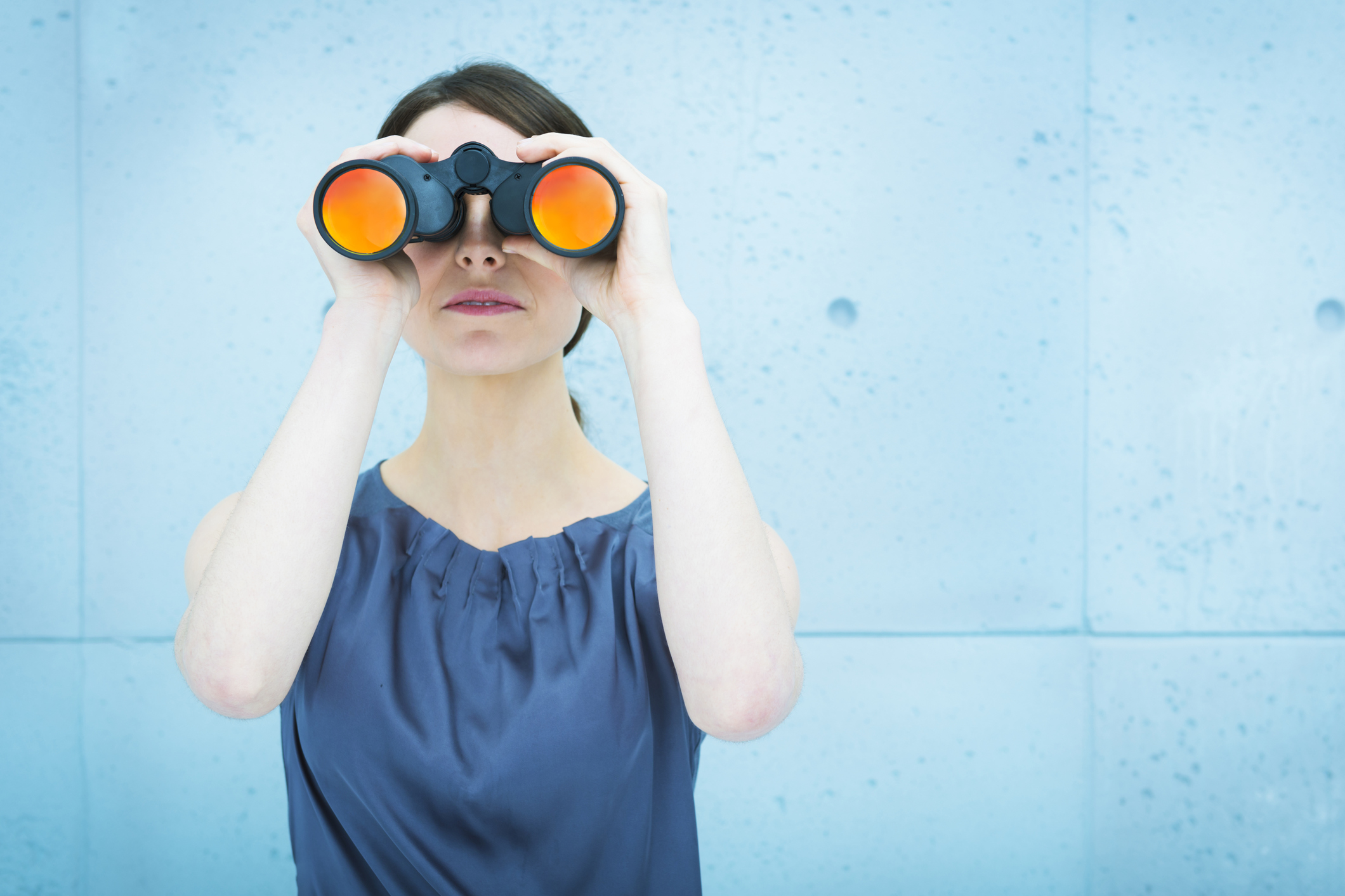 Businesswoman holding binoculars current telecommute jobs