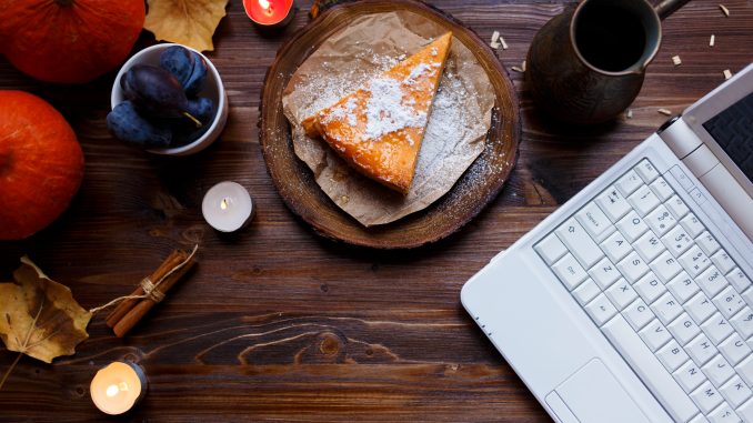 Desktop. Laptop, breakfast, pumpkin cheesecake, table lamp, pumpkins, plums on a wooden table. remote job openings