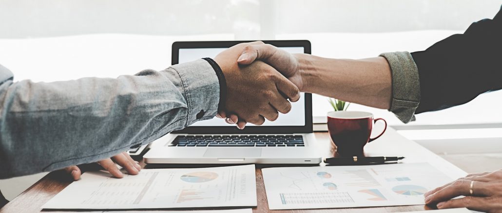 Business Handshake Shake hands with clients after negotiating freelance rates.